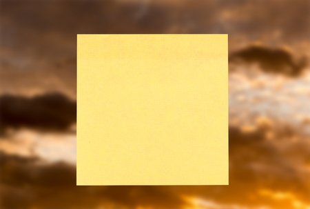 A yellow post-it to write on a nice backgroundの写真素材