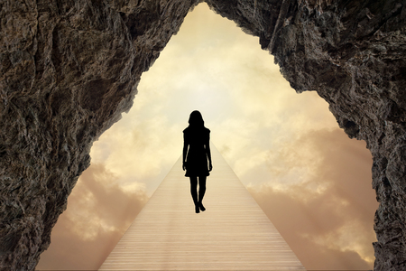 A path that goes towards the bright white lightの写真素材