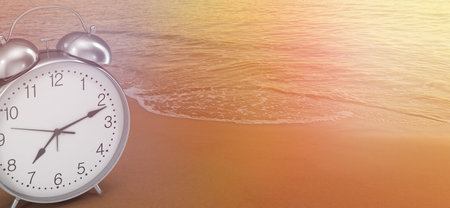 An alarm clock on the seashore at sunrise, Spain