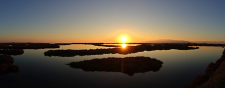 Panoramic of a sunset in the delta del ebro of tarragona, Spainの写真素材