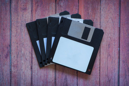 Antique pc diskettes on a brown wooden background