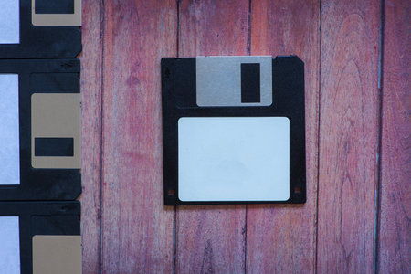 Antique pc diskettes on a brown wooden background