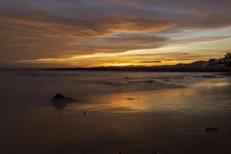 Nice sunset on a beach of la renega, Oropesa, Spainの写真素材