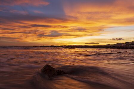Nice sunset on a beach of la renega, Oropesa, Spainの写真素材