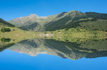 A lake in the mountain under the blue sky, manipulationの写真素材