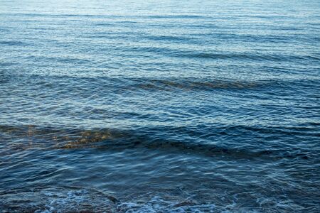 Calm waves on the shore of the blue sea, Spainの写真素材