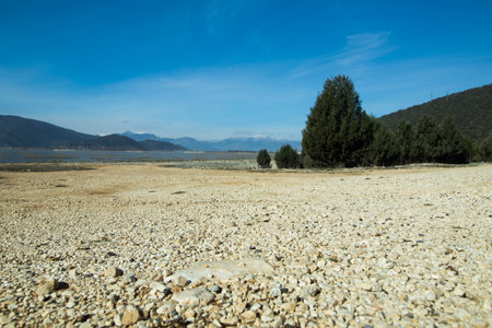 solitude landscape with lake, mountains and skyの写真素材