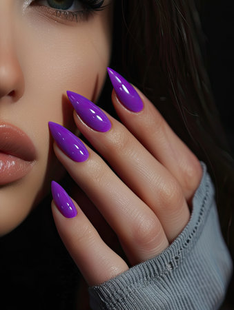 Beautiful girl with bright purple nail polish on a black background.の素材