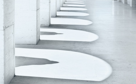 Porch section , the arches and statues  shadows are reflected  on the floor ,the building is covered of marble ,wide angle lens  from the bottom to the  top to enphasize the buildind shapeの写真素材