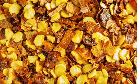 Small flakes of red pepper , the crunched peppers are red and yellow ,studio shot , top view ,の写真素材
