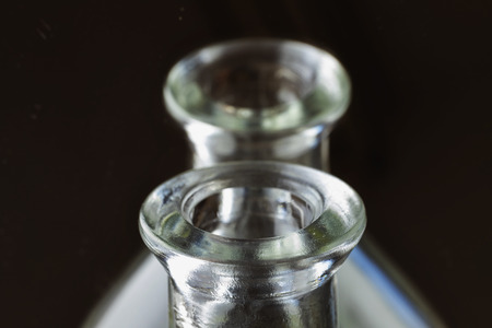 Beautiful upper surface of a glass bottle  , in the background the bottle is reflected in  the mirror , macro photographyの写真素材