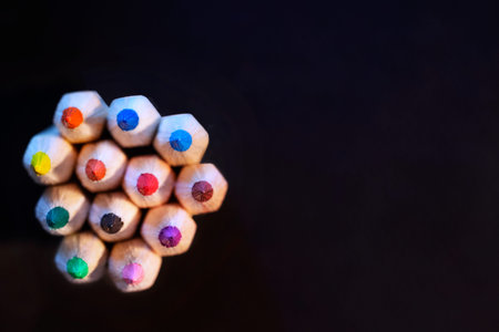 Top of wooden color pencils on black background , studio shot
