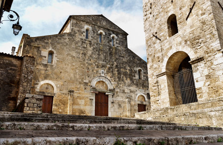 ANAGNI-ITALY-July 2020- facade of the cathedral and bell tower against blue sky, simple facade with...