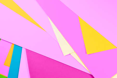 Sheet of multicolored paper background, yellow, pink, blue and purpleの写真素材