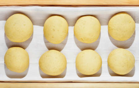 Balls of dough in wooden box, baking preparationの写真素材