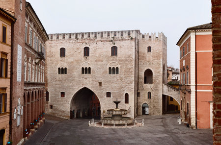 Fabriano ,Italy , Piazza del comune with gothic Palazzo del Podestawith swallow-tail battlements , Sturinalto Fountain and Vescovile Palace with Torre Civicaの写真素材