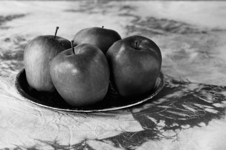Fresh apples on plate in black and white, healthy eatingの写真素材