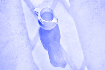 One white ceramic jug with shadows