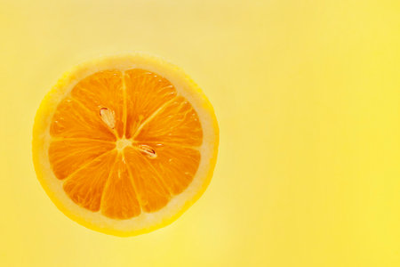 Fresh slice of lemon on yellow background, healthy eatingの写真素材