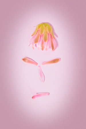 Beautiful angry face portrait made with flower petals, difficult relationshipの写真素材