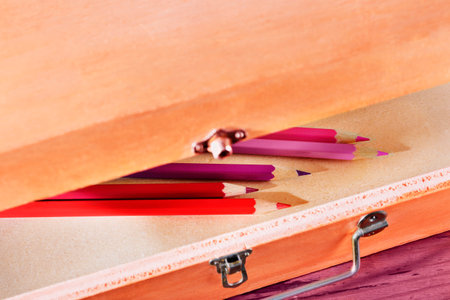 Pointed red and pink wooden pencils in pencil box, place of work or leisure timeの写真素材