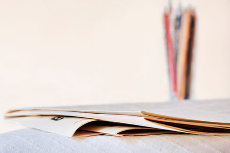 Folded newspapers on table, leisure time or professional occupation,