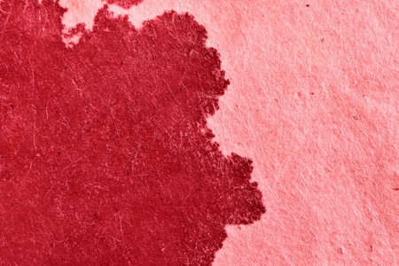 Sheet of paper with red paint or blood splatter stainの写真素材