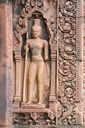 Stone carving of a Dvarapala (door guard) at Banteay Srei, Siem Reap, Cambodia.の写真素材