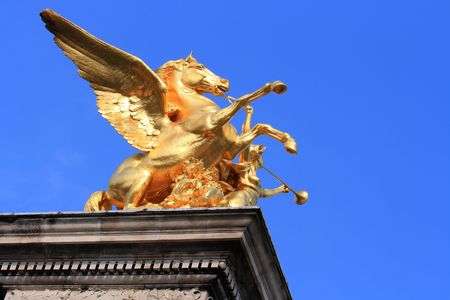 Golden Horse in Paris with Blue Skyの写真素材