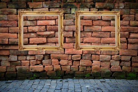 two vintage photo frames hanging in roomの写真素材