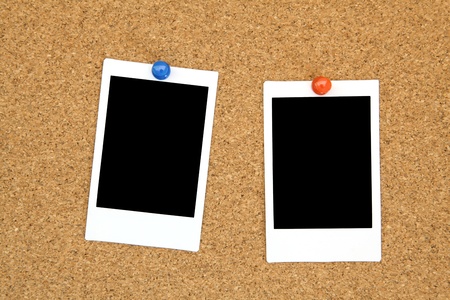 two blank instant photo frame on notice cork boardの写真素材