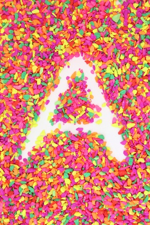 The letter A alphabet and font made of colorful rock stoneの写真素材