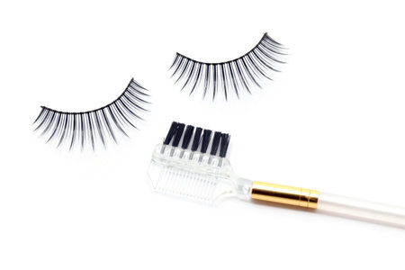 False eyelash mascara and make-up brush isolated on white 
