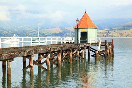 motor boat jetty pier building on lake at Akaroa New Zealandのeditorial素材