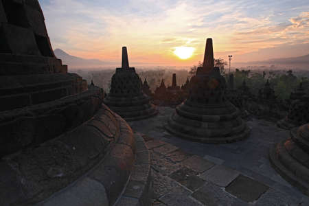 Silhouette of Ancient stupa Borobudur Temple, sunrise in Yogyakarta, Java, Indonesia.の写真素材