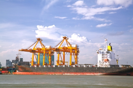 Container Cargo freight Industrail ship with working crane bridge unloading and loading goods in Bangkok shipyard Terminal for Logistic Import Export backgroundの写真素材