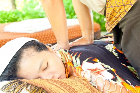Back Massage Spa with Hand in tropical garden for wellness and healthy backgroundの写真素材