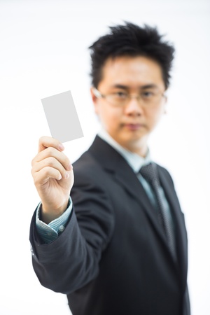 Businessman holding business name card isolated over white backgroundの写真素材