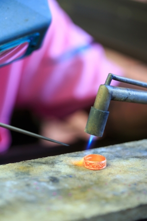 Goldsmith working with a thai traditional ringの写真素材