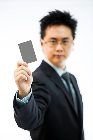 Businessman holding business name card isolated over white background (selectice focus)の写真素材