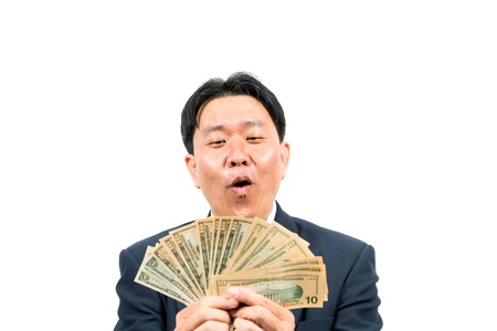 Businessman holding money isolated over white backgroundの写真素材