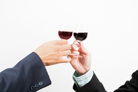 Close-up of human hands cheering up with flutes of wineの写真素材