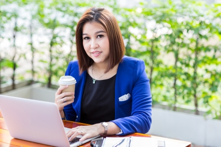 Young businesswoman working laptop with coffeeの写真素材