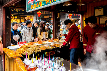 CHONGQING, CHINA - JAN 17: Unidentified merchants are selling traditional food on January  17, 2014 at Ciqikou Ancient Town, Chongqing, China.