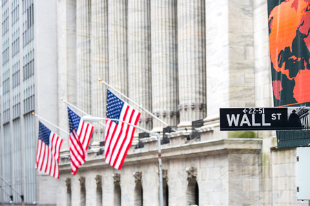 Wall street sign in New York with New York Stock Exchange の写真素材