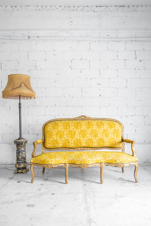 Yellow Classical style Armchair sofa couch in vintage room with desk lampの写真素材