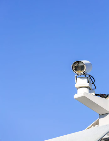 CCTV security camera over blue sky