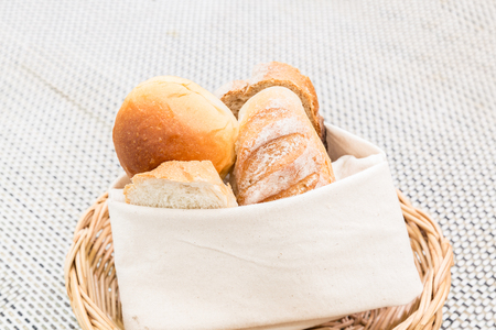 Fresh bread in the basket. Food background.の写真素材