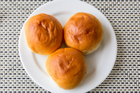 Dinner roll bread Fresh baked in white plate for dinner courseの写真素材