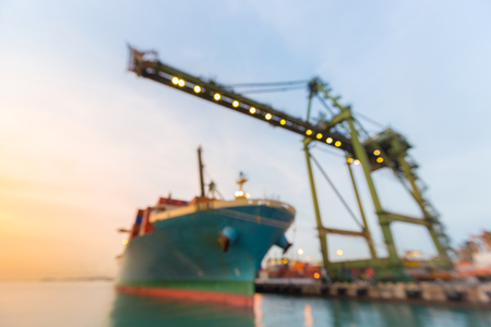 Blurred abstract background of Industrial port with container ship at duskの写真素材